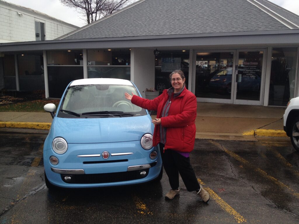 Luigi Lucia the light blue Fiat with J. Keely Thrall standing beside the car